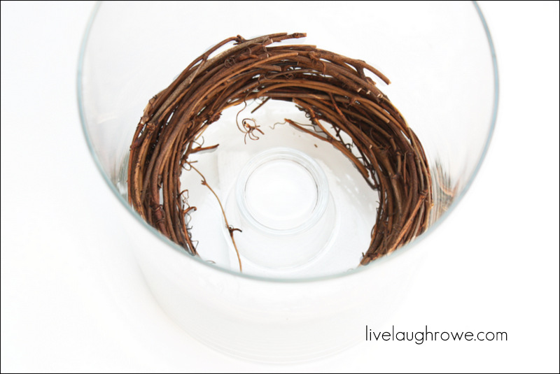 place wreath in the vase with tea light candle holder if you need to raise the pillar candle