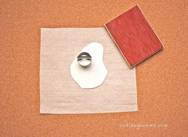 Using the rubber stamp with wood grain to stamp the polymer clay.